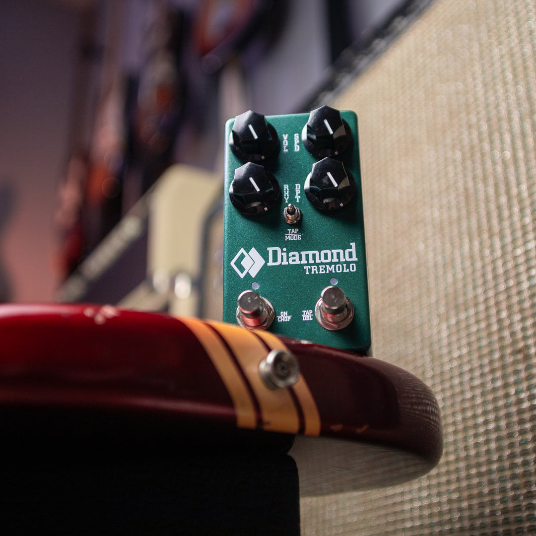 DIAMOND TREMEMO MODULATION PEDAL ANGLED UP VIEW ON GUITAR AMP BACKGROUND