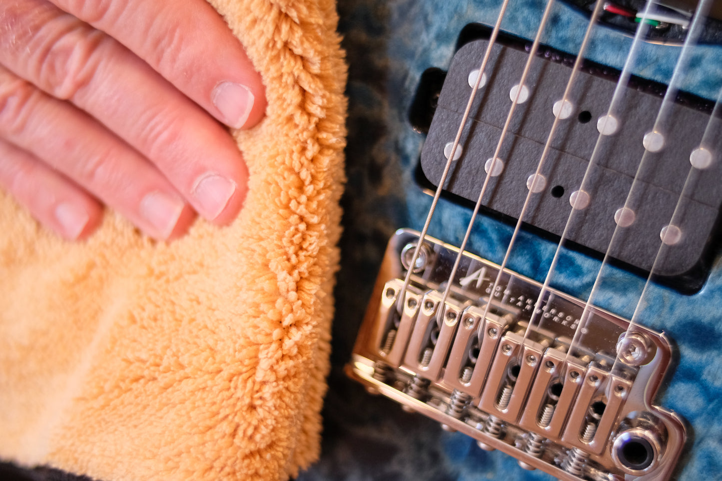 MusicNomad mn241 DEMO PHOTO HAND POLISHING BLUE GUITAR CLOSEUP PHOTO