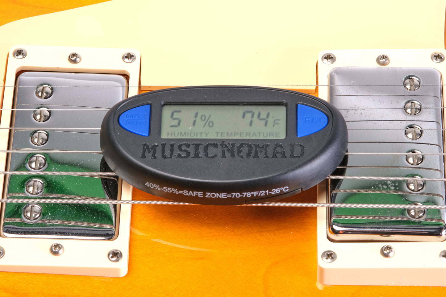MUSICNOMAD MN312 GUITAR HYGROMETER FRONT TOP ANGLED VIEW ON ELECTRIC GUITAR DUAL HUMBUCKERS